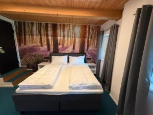 a large bed in a room with a window at Christians Weinblick in Mehrnbach