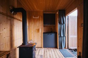 a woodburning stove in a room with a television at Tiny Glamp - Kontejner pod Pradědem in Rudná pod Pradědem