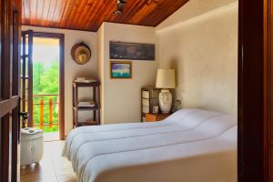 a bedroom with a large bed and a balcony at Residence Le Conifere - Villetta Esclusiva in Filettino Graziani
