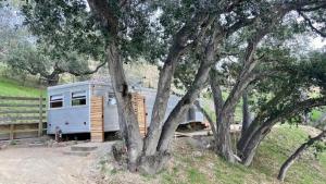 an rv is parked next to some trees at Vintage Spartan-retro Farm Stay W Ev Charger in Arroyo Grande