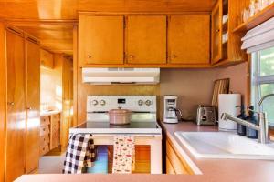 a kitchen with a stove and a sink at Vintage Spartan-retro Farm Stay W Ev Charger in Arroyo Grande