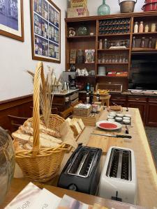 a kitchen with a table with a counter with baskets at Hotel San Lázaro in Santiago de Compostela +28 photos
