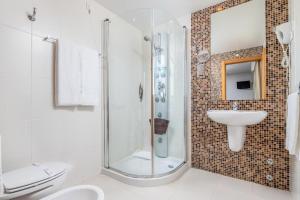 a bathroom with a shower and a sink and a toilet at Stay Hotel Leiria Centro in Leiria +27 photos