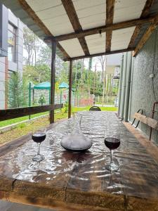 two glasses of red wine sitting on a wooden table at BaBu shekvetili in Shekhvetili
