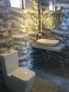 a bathroom with a toilet and a sink at Maali holiday Apartments in Hiriketiya +38 photos
