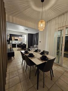a dining room with a white table and chairs at Freshly Renovated - 3 Bedroom Villa 5min Walk to Beach - LB3 in Flic-en-Flac +15 photos