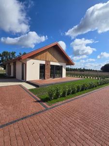a rendering of a house with a brick driveway at Eko Osada Zacisze in Ostrowite