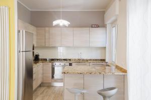 a kitchen with white cabinets and a counter top at Ampio appartamento in centro Pescaramare in Pescara +32 photos