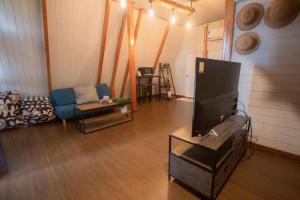 a living room with a flat screen tv on a table at นานาเพชรบูรณ์ รีสอร์ท&คาเฟ่ 