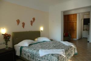a bedroom with a large bed with two pillows at Santa Maura in Nydri