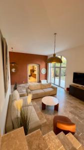 a living room with a couch and a table at La grange du château Favor in Bourg-de-Péage +21 photos