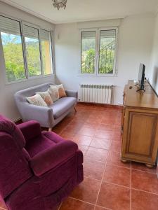 a living room with a couch and a chair at 3Raigaños Vivienda Vacacional in Sales