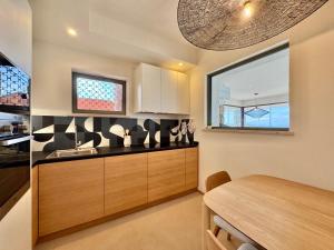 a kitchen with a table and a dining room at Casa Ponente in Porto Santo Stefano +6 photos