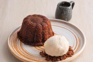 a piece of cake with ice cream on a plate at BelAire Bangkok Sukhumvit in Bangkok +85 photos