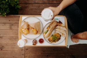 a tray of food with two plates of food on it at Tiny Glamp - Kontejner Šikmina in Dolní Moravice +6 photos