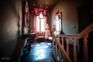 a woman standing in a room with a window at Le domaine du château blanc à 10 minutes de Pairi Daiza in Jurbise +28 photos