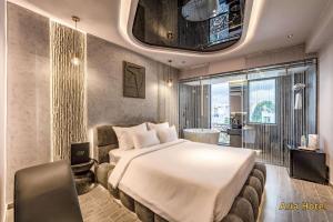 a hotel room with a large bed and a window at Oria Hotel Gò Vấp in Ho Chi Minh City