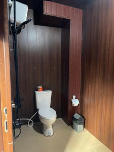 a bathroom with a toilet in a wooden wall at Aura Cendana Hill Sidemen in Selat +45 photos