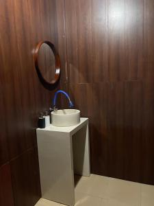 a bathroom with a sink and a mirror at Aura Cendana Hill Sidemen in Selat