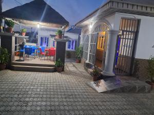 a house with a patio and a table and chairs at GOCAP Guest house in Rubuchi