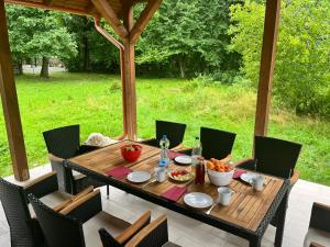 a wooden table and chairs on a patio at Luca-lak in Izvoare