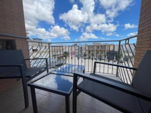 a balcony with two chairs and a glass table at B&B CORSO ROMA Room Suite & Spa in Apricena