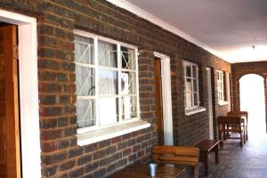 a brick wall with a window in a room at Delion Lodge in Koster