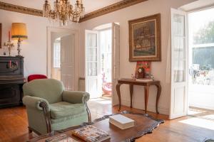a living room with a chair and a table at Lutzin Etxea, Caserío Vasco con piscina, jardín y parking, a 15 min de Bilbao in Llodio