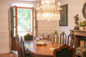 a dining room with a table and a chandelier at Lutzin Etxea, Caserío Vasco con piscina, jardín y parking, a 15 min de Bilbao in Llodio +38 photos