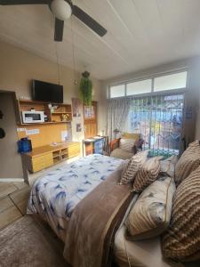 a bedroom with a large bed and a window at Primrose Accommodation in George