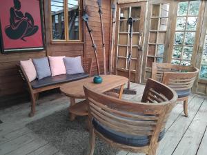 a porch with chairs and a table and a couch at Chalet Banassac in Saint-Ambroix