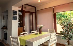a dining room with a table and chairs and a window at Melone Apartman 3 Senj by Villas Guide in Sveti Juraj