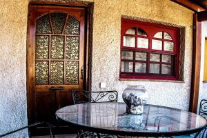 a glass table with a vase sitting on top of it at Castle's House in Véssa