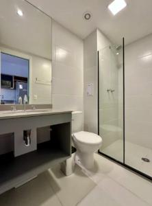 Un baño con inodoro, lavabo y ducha. en Campo Belo Brand New Studio, en São Paulo