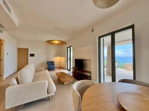 a living room with a table and a couch at Casa Levante in Porto Santo Stefano