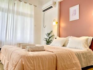 a bedroom with a large bed with two pillows on it at The Driftwood Dan Studio Flat Colva, anirah in Colva
