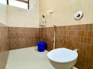 a bathroom with a toilet and a shower at The Driftwood Dan Studio Flat Colva, anirah in Colva +7 photos