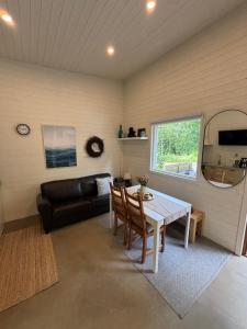 a living room with a table and a couch at Tiny House in Killeberg