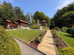 a garden with a house in the background at Pensiunea Aby in Sovata +23 photos