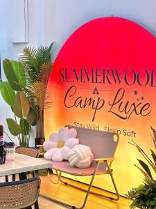 a sign for a camp lounge with flowers on a table at Afamosa Sunset Villa 22pax Snooker BBQ KTV New in Kampong Ulu Pegoh