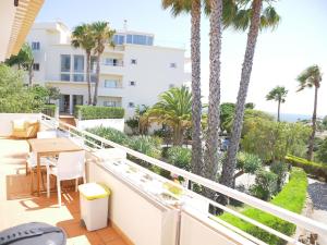 a balcony with palm trees and a view of the ocean at Large three-bedroom apartment in Lagos