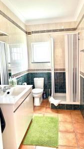 a bathroom with a sink and a toilet and a shower at Large three-bedroom apartment in Lagos +18 photos