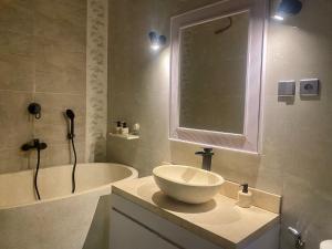 a bathroom with a sink and a bath tub at Palm Light Nusa Dua in Nusa Dua +13 photos