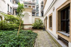a courtyard in a building with a small tree at Beautiful Apartment 3 City Center in Vienna