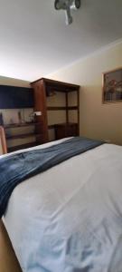 a bedroom with a large white bed with a door at The Cottage on 3rd in Johannesburg