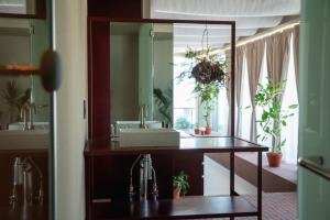 a bathroom with a sink and a mirror at SOIL Nihonbashi Hotel in Tokyo