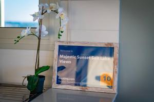 a clock sitting on a table with a flower in a vase at Majestic Sunset Salt Lake Views 300m From Beach in Larnaka +245 photos