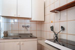 a kitchen with a sink and a counter with utensils at B&B Masseria Donna Carlotta in Serrano +40 photos