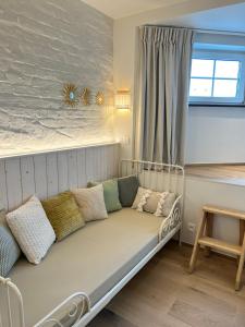 a couch sitting in a room with a window at Z' Evita in Nieuwpoort +37 photos