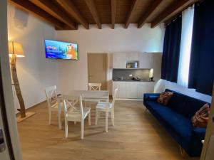a living room with a table and a blue couch at International Residence in Tarvisio